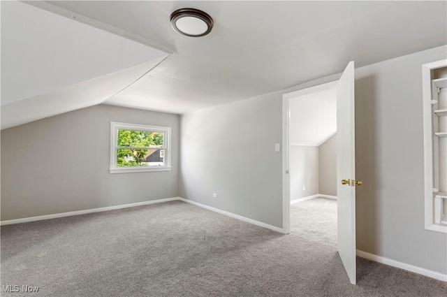 bonus room featuring lofted ceiling and carpet flooring