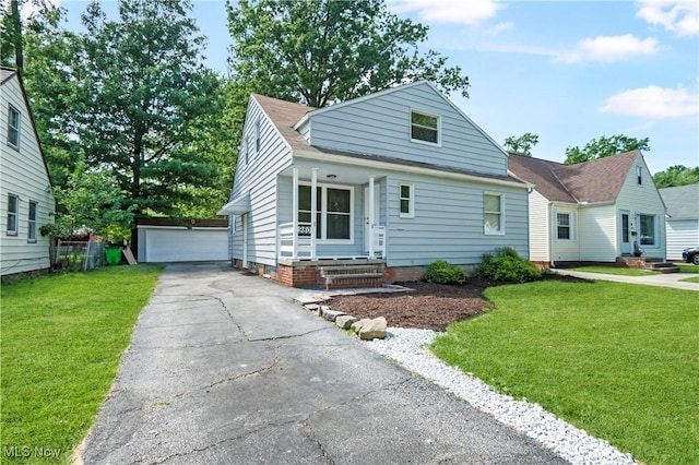 view of front of house with a front yard, a garage, and an outdoor structure