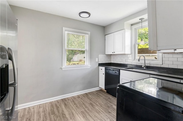 kitchen featuring sink, white cabinets, light hardwood / wood-style flooring, backsplash, and black appliances