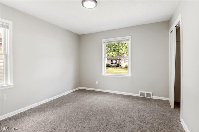 unfurnished bedroom with a closet and carpet flooring