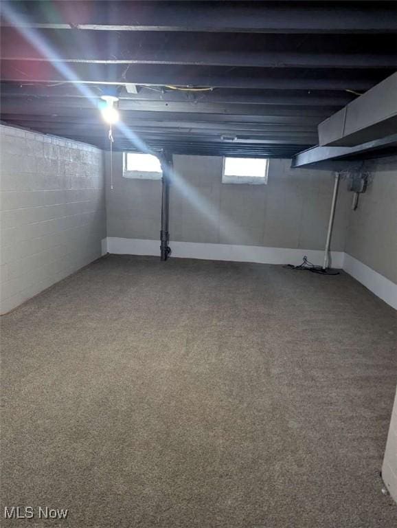 basement with a wealth of natural light and carpet