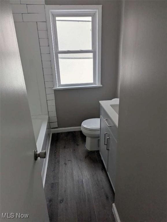 bathroom featuring hardwood / wood-style floors, vanity, and toilet