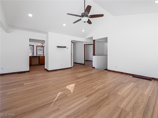 unfurnished bedroom with ceiling fan with notable chandelier, light hardwood / wood-style floors, and vaulted ceiling