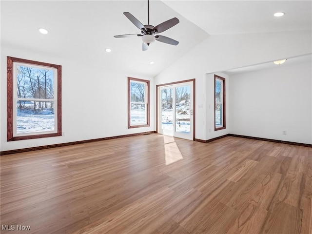 unfurnished room with lofted ceiling, ceiling fan, and light hardwood / wood-style floors