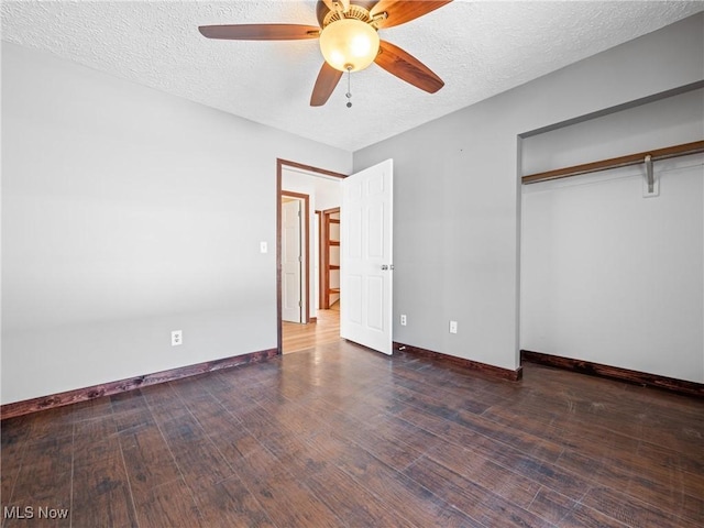 unfurnished bedroom featuring a textured ceiling, ceiling fan, a closet, and dark hardwood / wood-style floors