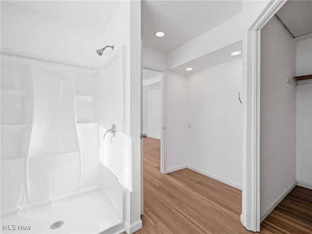 bathroom featuring wood-type flooring and a shower