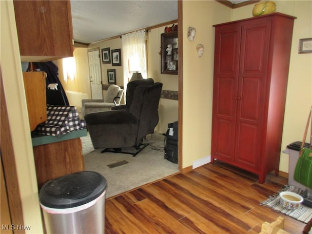 living room featuring wood-type flooring and ornamental molding