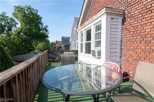 wooden balcony with cooling unit and a wooden deck