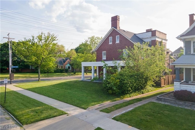 exterior space featuring a lawn and a pergola