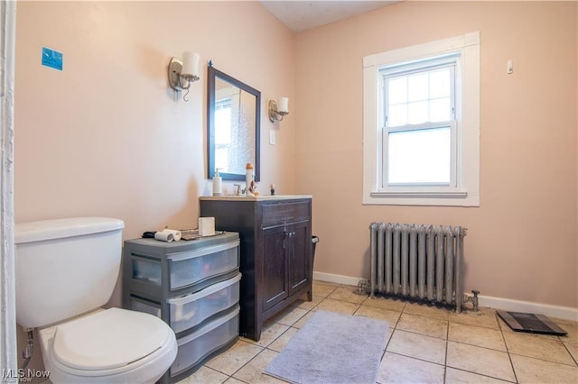 bathroom with radiator, tile patterned flooring, toilet, and vanity