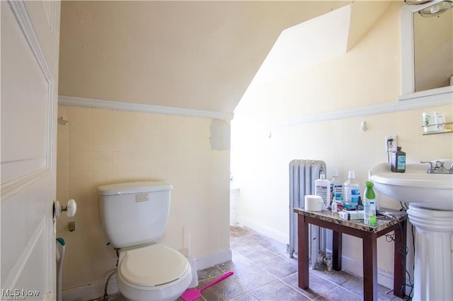 bathroom with sink, toilet, and radiator