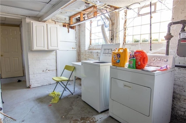 washroom with cabinets and washer and clothes dryer