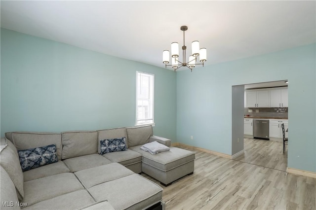 living room with a chandelier and light hardwood / wood-style flooring