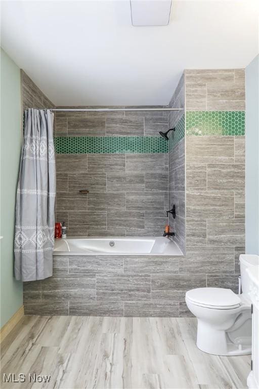 bathroom with toilet and shower / bath combo