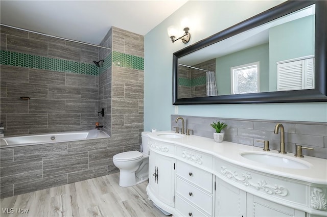 full bathroom featuring toilet, wood-type flooring, shower / bath combination with curtain, backsplash, and vanity