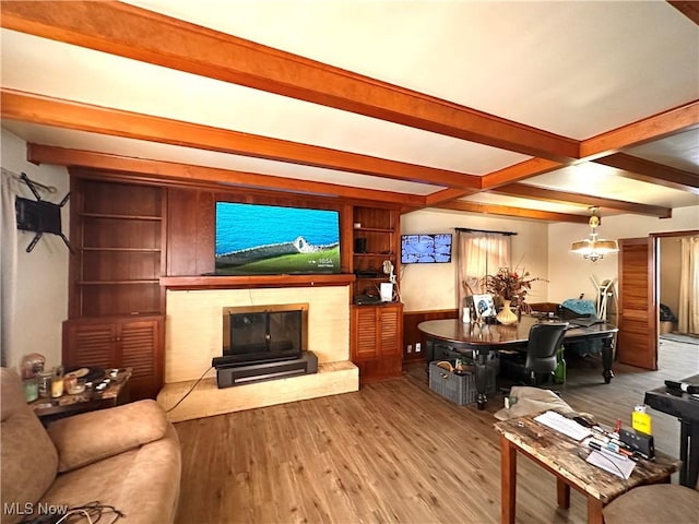 living room featuring beamed ceiling, a chandelier, and hardwood / wood-style flooring