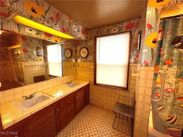 bathroom with vanity and tile walls