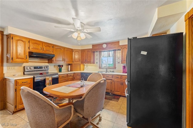 kitchen featuring sink, light tile patterned floors, ceiling fan, and black appliances