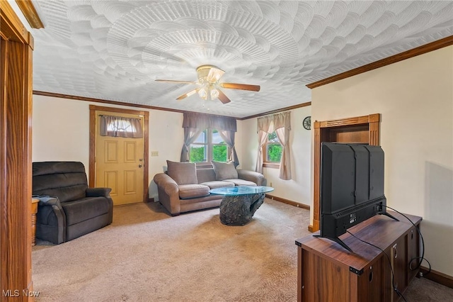 carpeted living room with a textured ceiling, ceiling fan, and ornamental molding