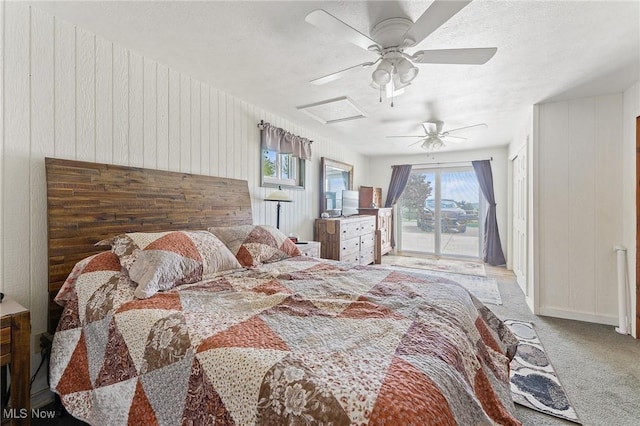 bedroom featuring wooden walls, light carpet, ceiling fan, and access to outside