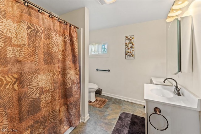 bathroom featuring toilet and vanity