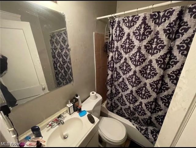 full bathroom with toilet, shower / bathtub combination with curtain, and vanity