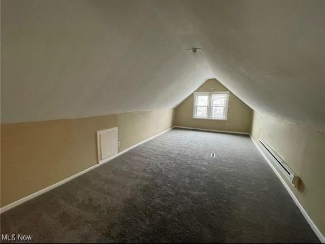 additional living space featuring lofted ceiling, a baseboard radiator, and carpet flooring