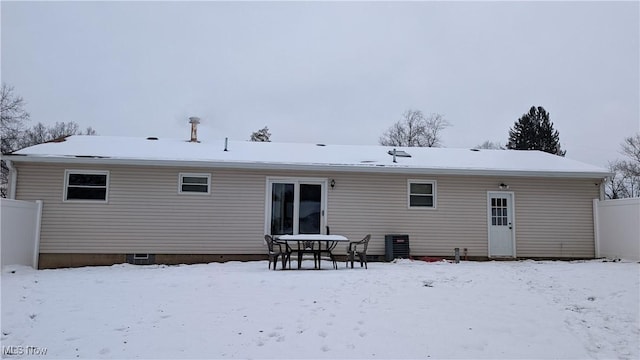 snow covered property featuring central AC unit