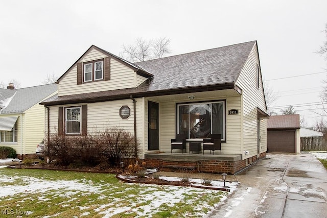 view of front of property featuring a yard, a garage, and an outdoor structure