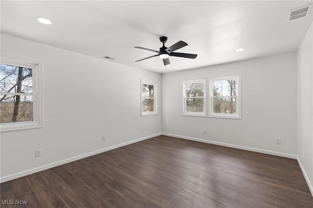 spare room featuring ceiling fan and dark hardwood / wood-style flooring