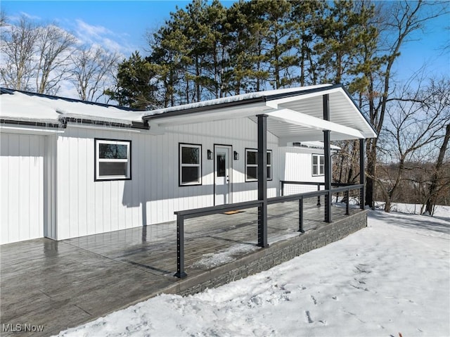 view of snowy exterior with a porch