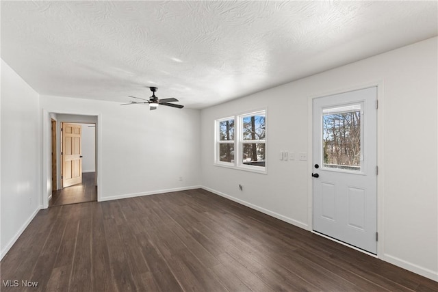 foyer entrance with ceiling fan, dark hardwood / wood-style flooring, and a textured ceiling