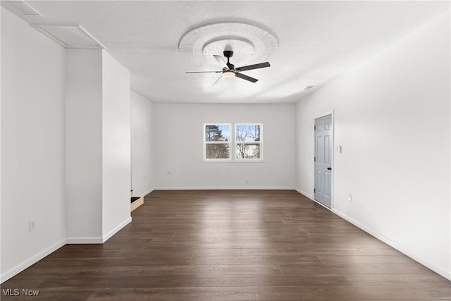 spare room with ceiling fan and dark hardwood / wood-style floors