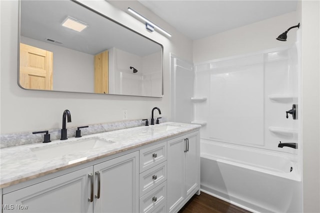 bathroom featuring shower / bathtub combination, vanity, and hardwood / wood-style flooring