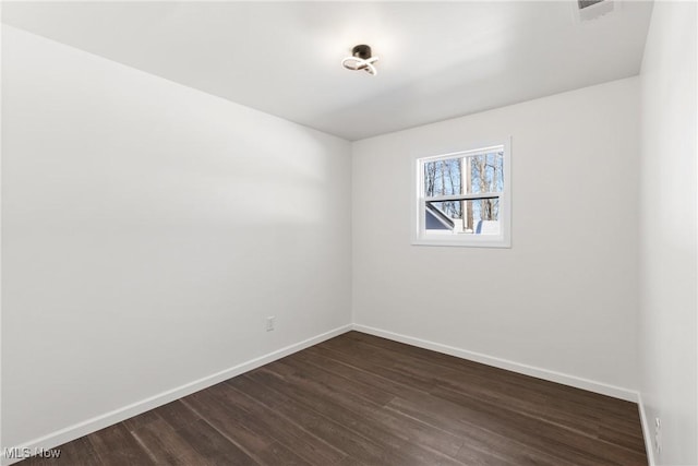 empty room featuring dark hardwood / wood-style flooring