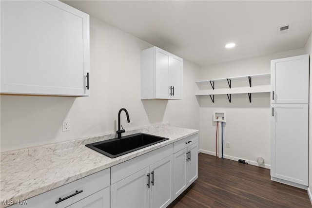 laundry area featuring sink, dark hardwood / wood-style flooring, and hookup for a washing machine