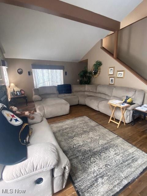 living room with vaulted ceiling with beams and wood-type flooring