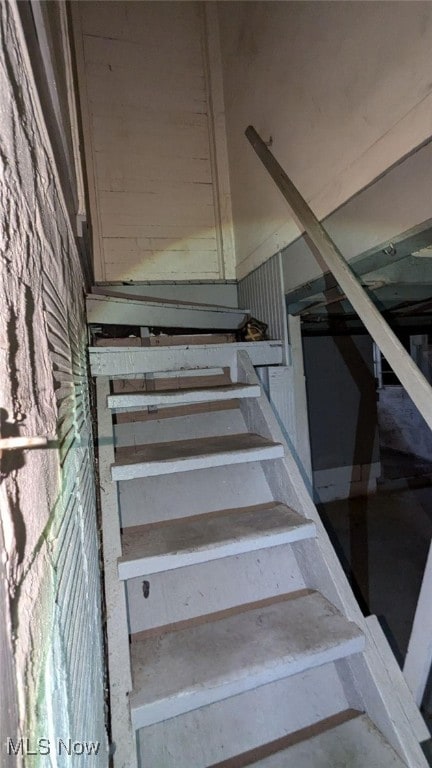 staircase with concrete flooring