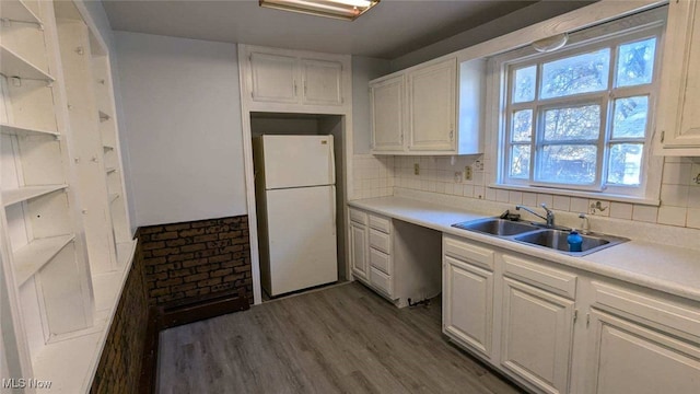 kitchen with sink, white cabinets, white fridge, tasteful backsplash, and dark hardwood / wood-style floors