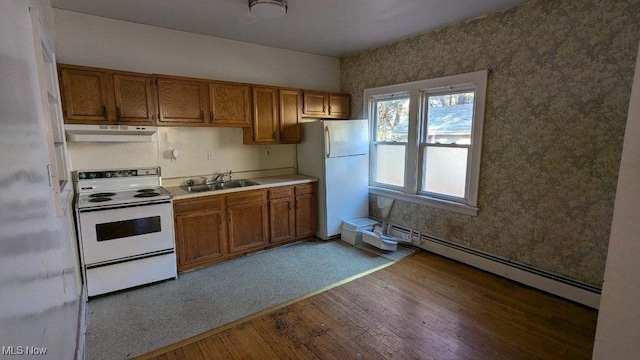 kitchen with white appliances, dark hardwood / wood-style flooring, a baseboard radiator, and sink