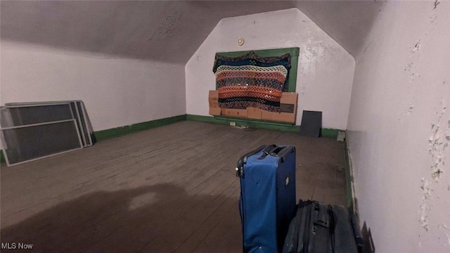 bonus room with hardwood / wood-style flooring and vaulted ceiling