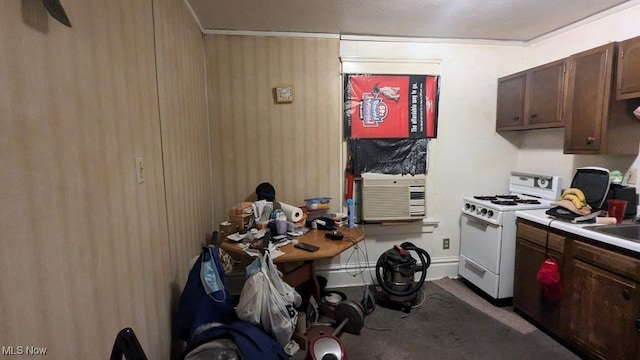 kitchen with dark brown cabinets and white gas range