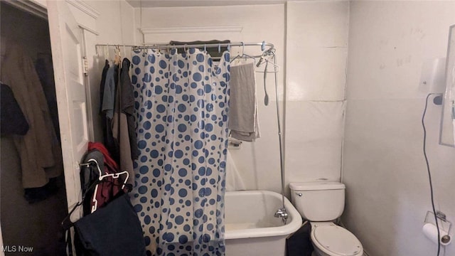 bathroom with shower / bath combination with curtain and toilet