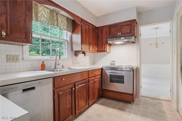 kitchen with an inviting chandelier, appliances with stainless steel finishes, sink, decorative light fixtures, and backsplash