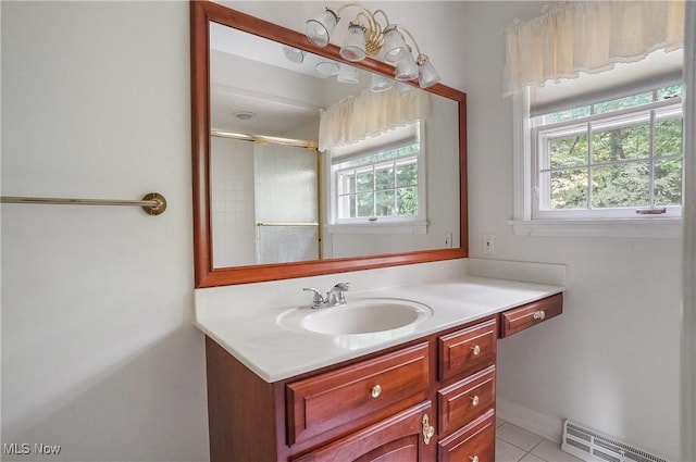 bathroom with walk in shower, vanity, tile patterned floors, and plenty of natural light