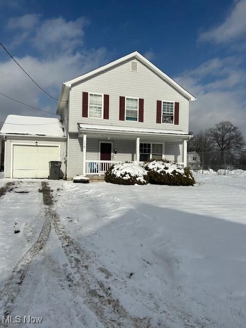 view of front property featuring a garage and covered porch