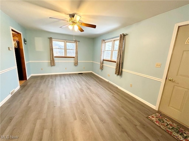 unfurnished room featuring ceiling fan and hardwood / wood-style flooring