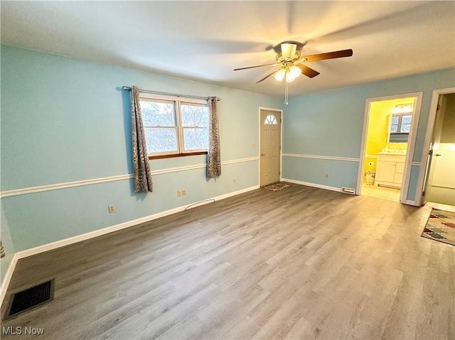 interior space featuring ceiling fan, connected bathroom, and hardwood / wood-style floors