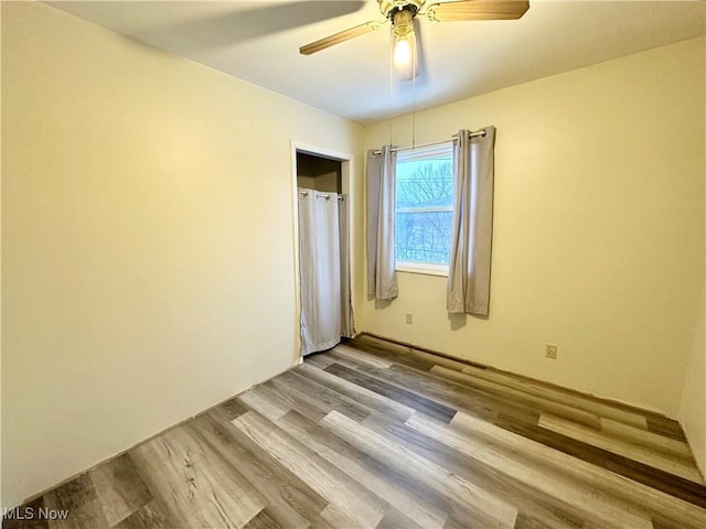 unfurnished bedroom featuring light wood-type flooring and ceiling fan