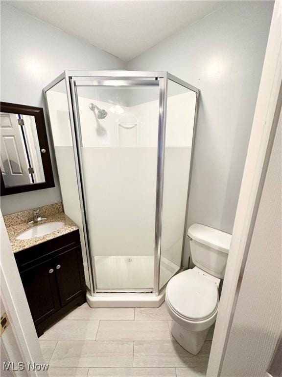 bathroom featuring walk in shower, vanity, and toilet